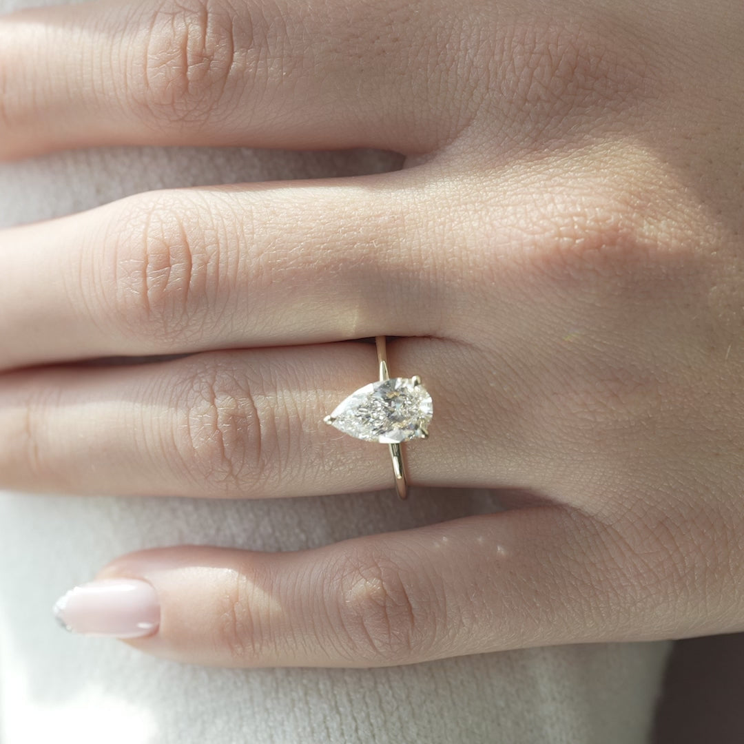 The Solitaire Harmony Pear Moissanite Ring_14k Yellow Gold
